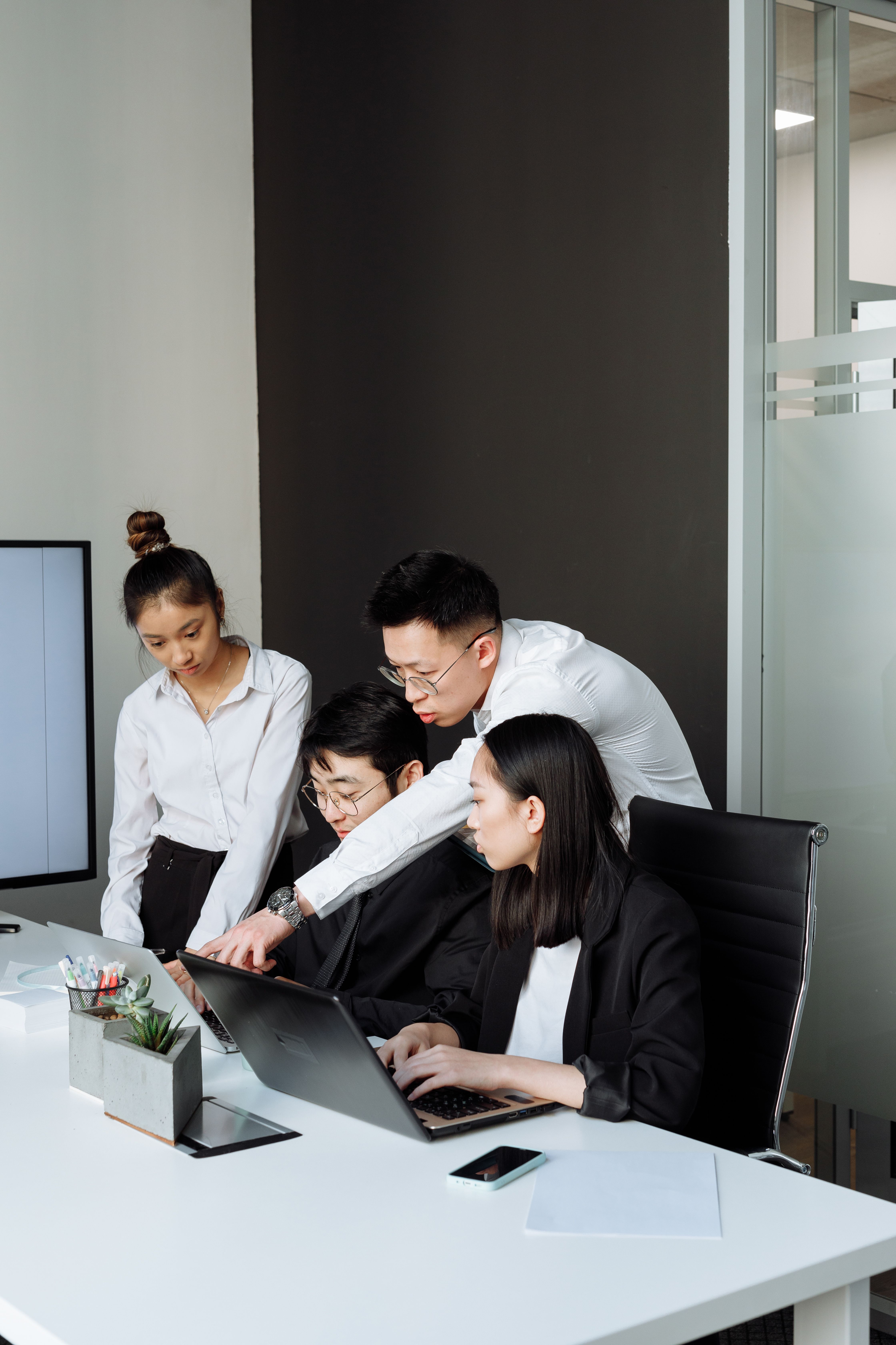 Team reviewing a client pipeline together on a laptop
